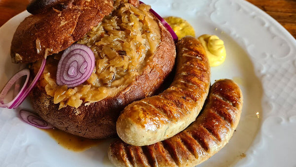 Grilled bratwurst with sauerkraut, mustard and rustic bread