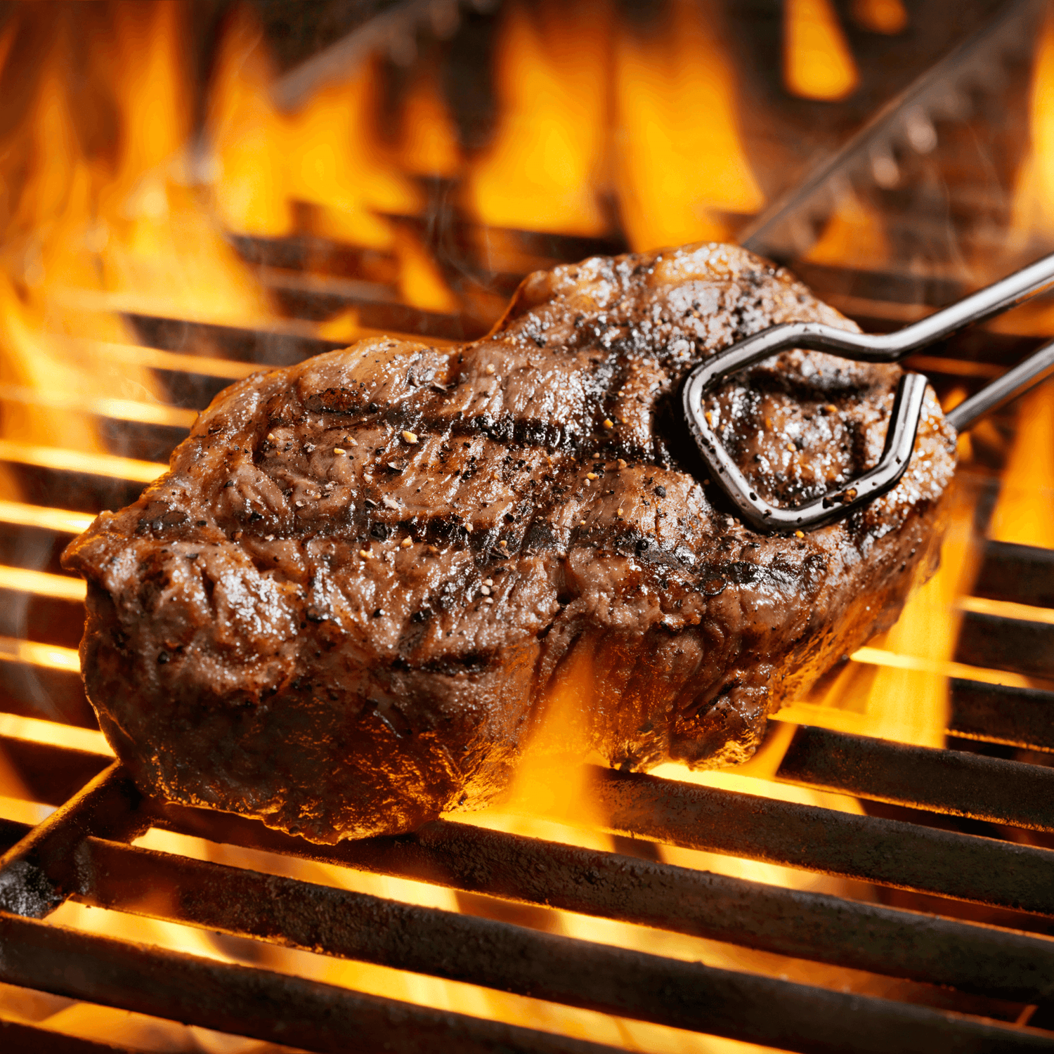 Juicy pasture-raised steak grilling over an open flame, showcasing fresh meat for an ultimate farm-to-table experience.