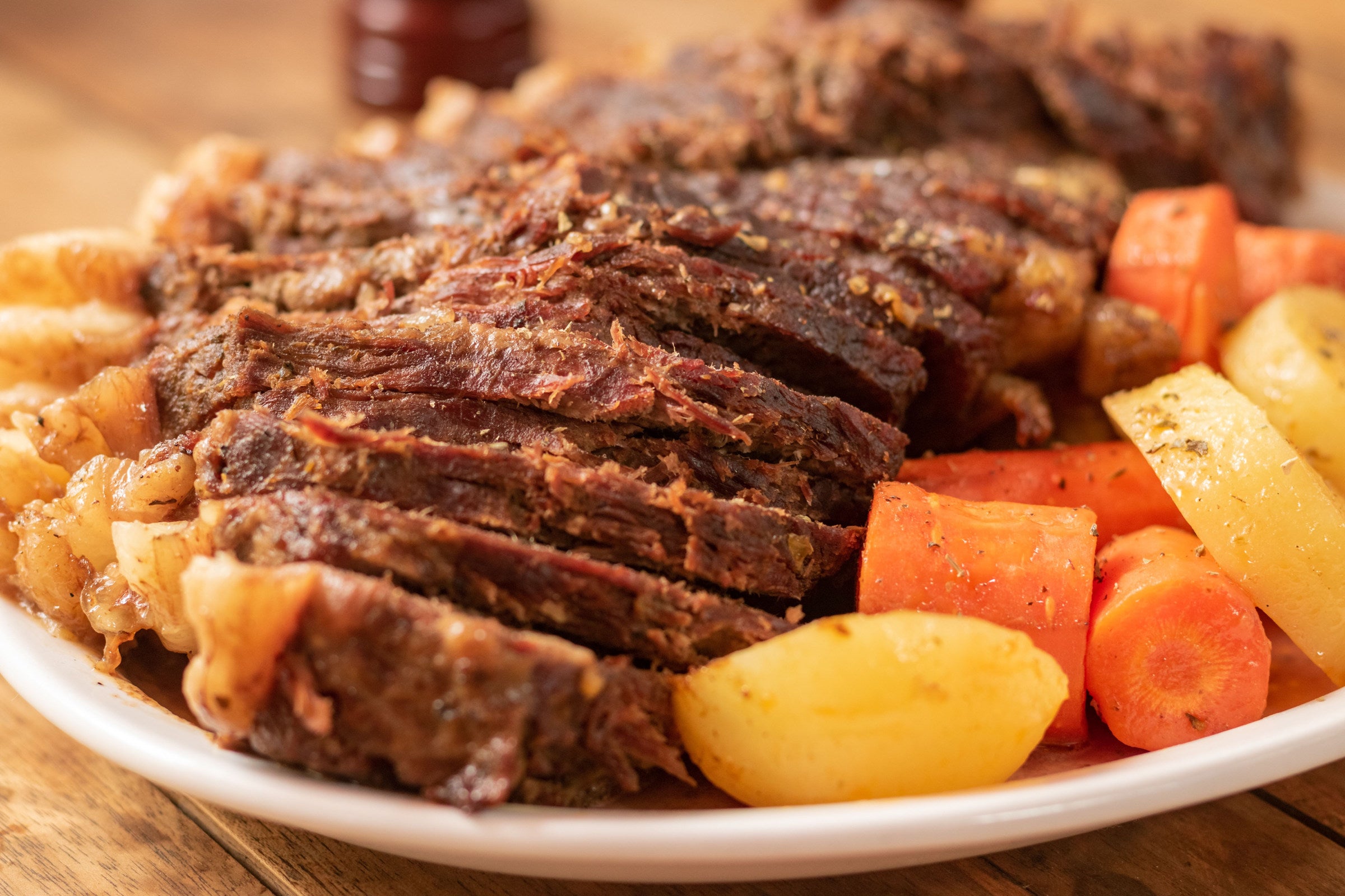 Slow-cooked beef roast, carrots and potatoes are visible