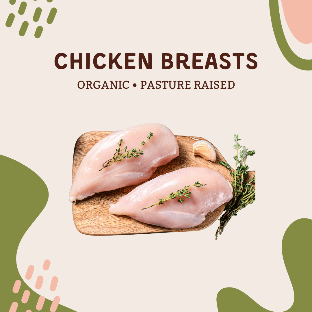 Pasture-Raised Chicken Breasts (2 lbs) displayed on a wooden board with herbs.